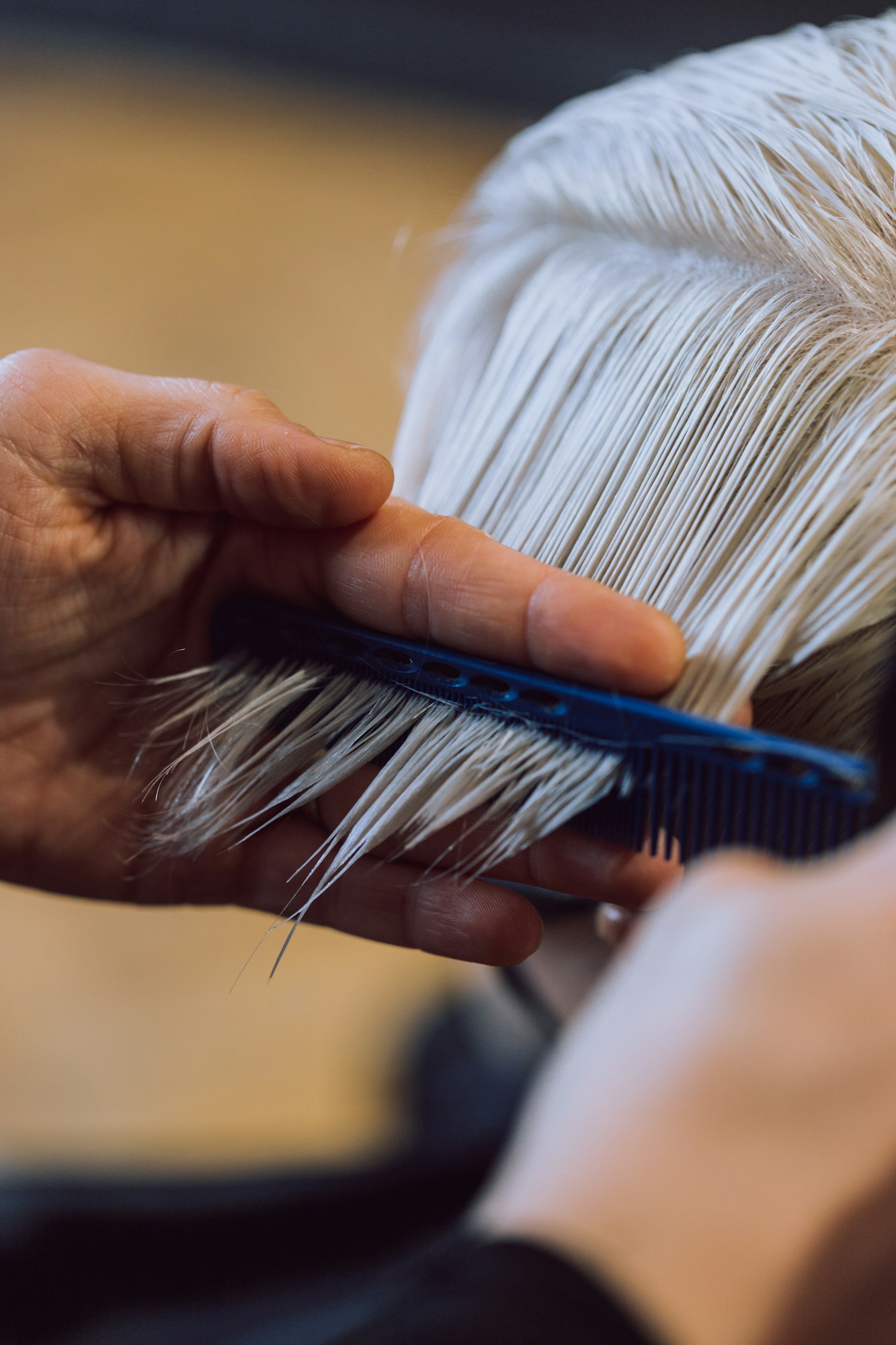 Detail of hair cutting with comb